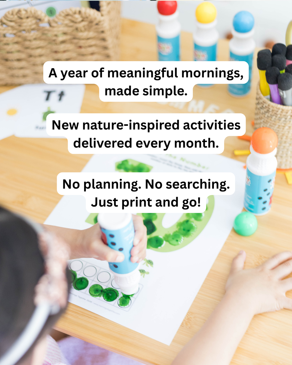 A child's hands are shown coloring a green leaf on a white paper activity sheet with blue paint pens and green beads on a wooden table. Other colorful craft supplies are visible in the background, with three white text bubbles containing promotional copy overlaid on the top half of the image.