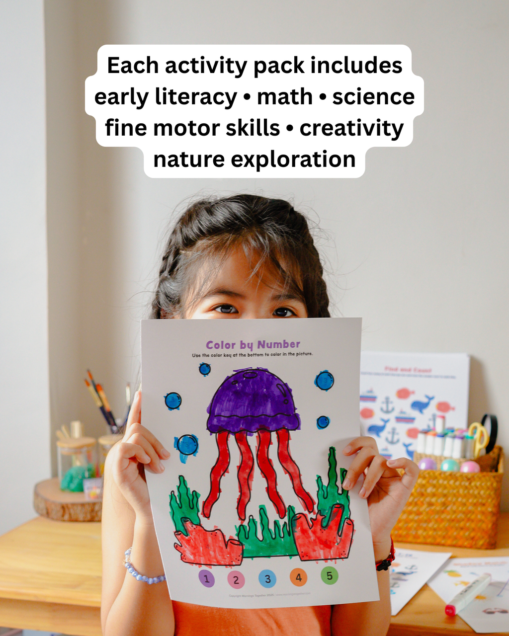 A young girl holds up a colorful 'Color by Number' activity sheet featuring a purple jellyfish and red tentacles, with text overlay at the top describing the educational activities included in each pack.