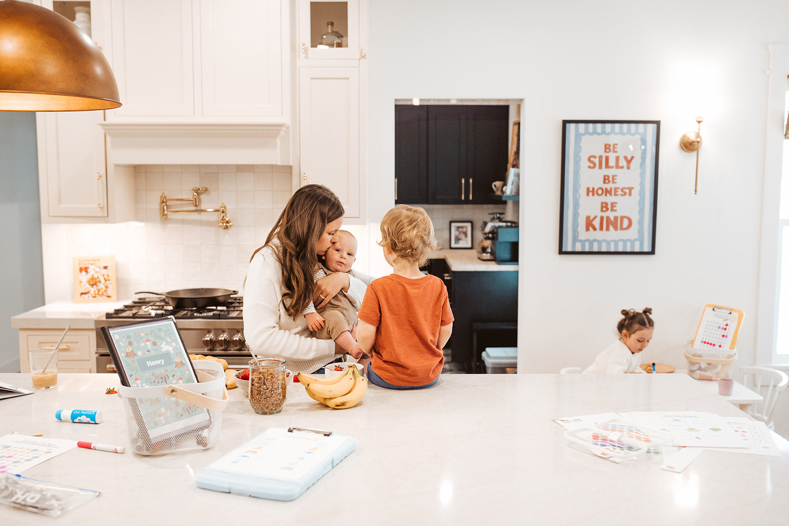 Woman with children in a modern kitchen setting